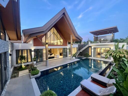 Luxurious house exterior with large swimming pool at twilight