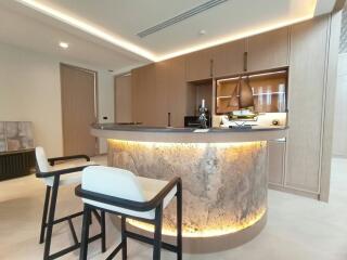 Modern kitchen with illuminated breakfast bar and elegant furnishings