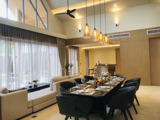 Elegant dining room with open-plan kitchen in the background