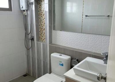 Modern bathroom with tiled walls and essential fixtures