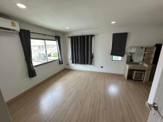 Spacious bedroom with natural light and air conditioning unit