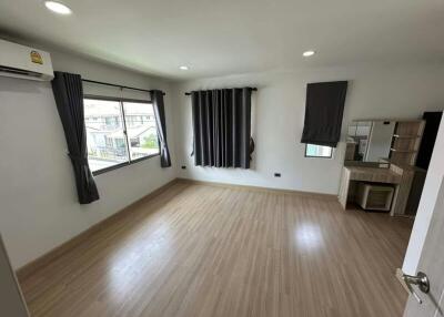 Spacious bedroom with natural light and air conditioning unit