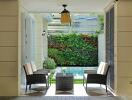 Elegant outdoor patio with wicker chairs and vertical garden