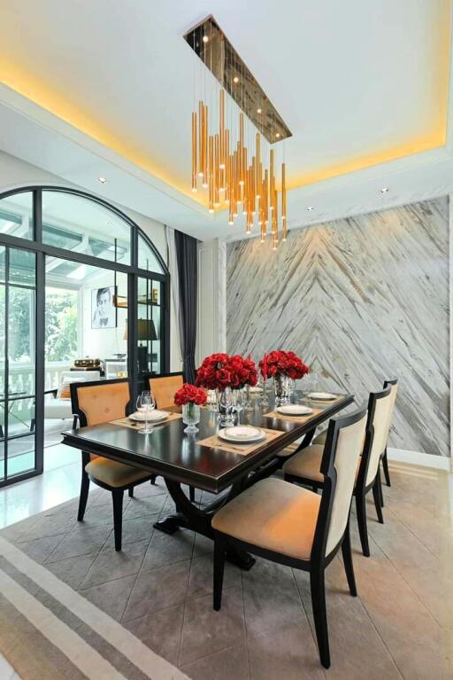 Elegant dining room with modern chandelier and marble walls