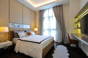 Elegant bedroom with modern furnishings and warm lighting