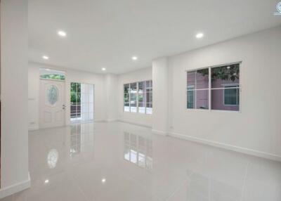 Spacious and well-lit empty living room with glossy floor