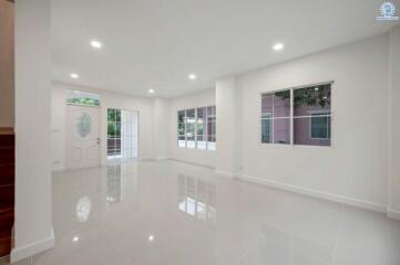 Spacious and well-lit empty living room with glossy floor