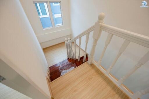 White staircase with wooden floors in a modern home