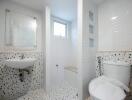 Modern bathroom with terrazzo-style flooring and white subway tile walls