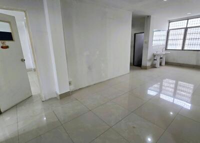 Spacious well-lit interior room with tiled flooring