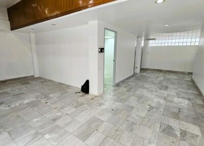 Spacious empty interior of a building with tiled flooring and white walls