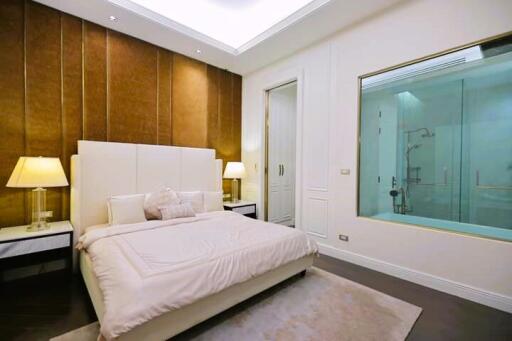 Modern bedroom with en-suite glass-enclosed shower