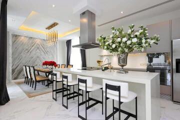 Modern kitchen with marble flooring and integrated dining area