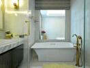Modern bathroom with white bathtub, elegant fixtures, and glass shower