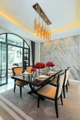 Elegant modern dining room with marble wall and luxurious chandelier