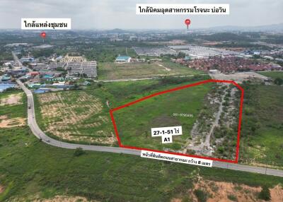 Aerial view of a vacant land plot for property development with markings and surrounding landscape