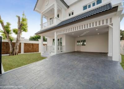 Spacious driveway of a two-story house with a gated fence