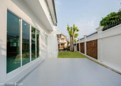 Spacious outdoor area with tiled patio and garden view
