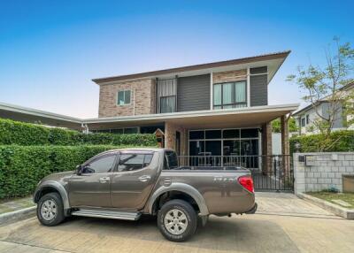 Modern two-story house with a pickup truck parked in the driveway