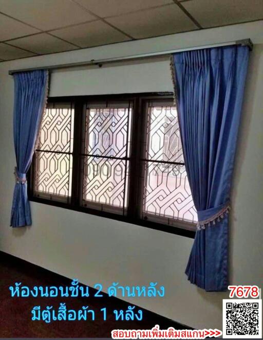 Room with large windows and blue curtains