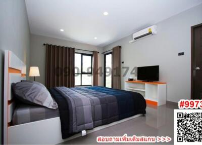 Modern bedroom with queen-sized bed, air conditioning, and flat-screen TV