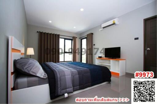 Modern bedroom with queen-sized bed, air conditioning, and flat-screen TV