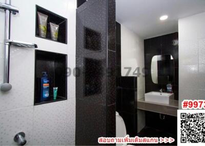Modern tiled bathroom with shower and mirror