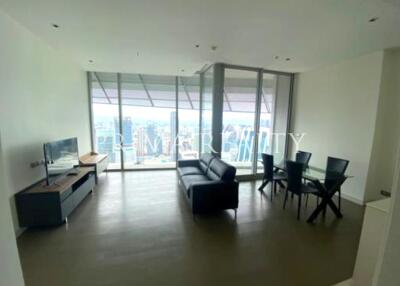 Spacious living room with modern furniture and large windows offering city views