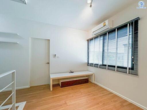Minimalist bedroom with wood flooring and window blinds