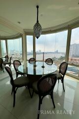 Elegant dining room with panoramic city view and stylish furniture