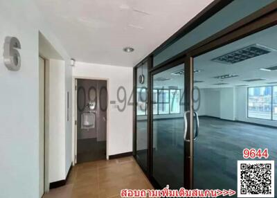 Spacious empty office space with large windows and ample natural light