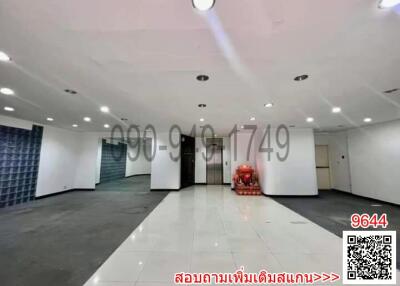 Spacious empty interior of a commercial building with tiled floors