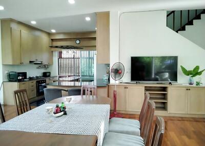 Spacious living area with kitchen, dining, and TV corner