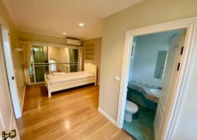 Spacious bedroom with adjoining bathroom and balcony access