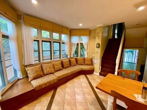 Spacious living room with large windows and comfortable seating
