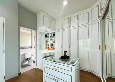 Spacious bathroom with white cabinetry and modern amenities