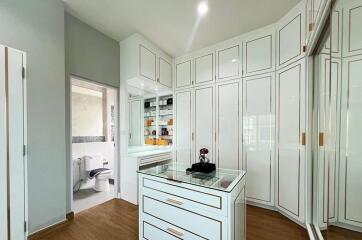 Spacious bathroom with white cabinetry and modern amenities