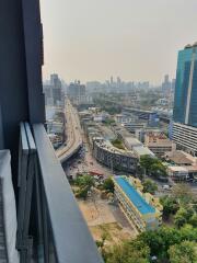Cityscape view from a high-rise building showcasing urban surroundings and thoroughfares