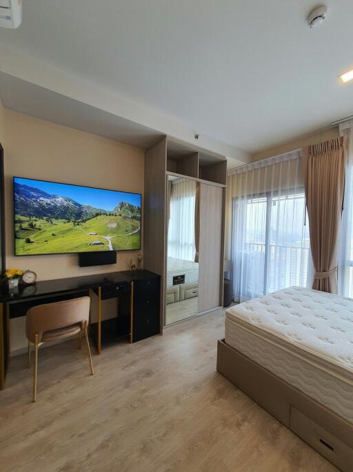 Cozy modern bedroom with a large bed and mounted television