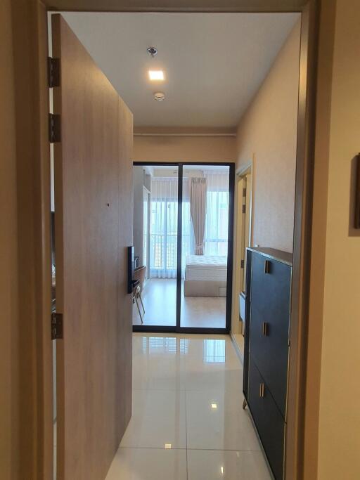 View from the entryway into a modern apartment unit with access to the main living area