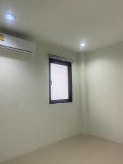 Minimalist empty room with air conditioning unit and single window