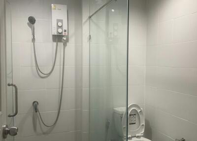 Modern bathroom with glass shower enclosure and white tiles