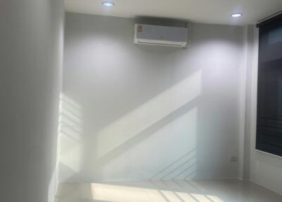 Interior view of a building highlightling air conditioning unit and staircase