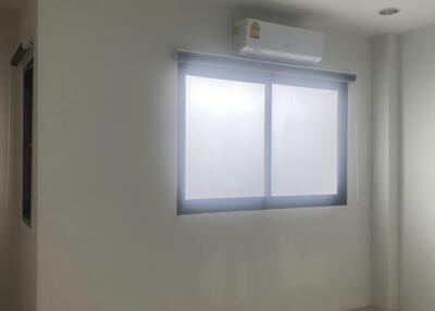 Bright bedroom with air conditioning unit and large window