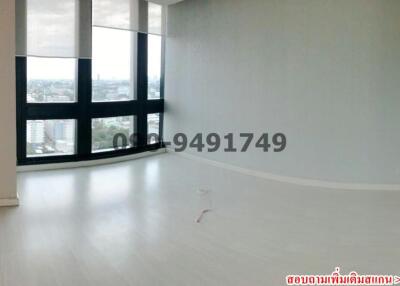 Spacious empty room with large windows and city view