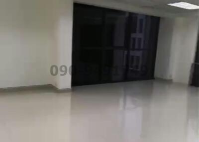 Spacious unfurnished commercial space with reflective flooring and drop ceiling