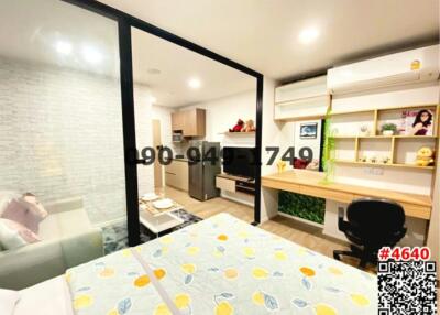 Compact bedroom with attached kitchen and study space