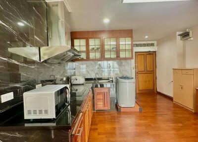 Spacious kitchen with modern appliances and marble flooring