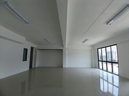 Spacious and well-lit empty living space with large windows