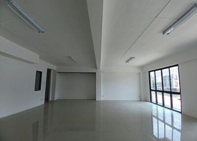 Spacious and well-lit empty living space with large windows